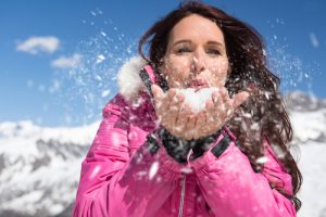 Women blowing snow at Camden Snow Bowl