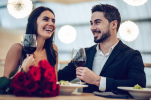 Couple having a romantic dinner during their romantic getaway in Maine