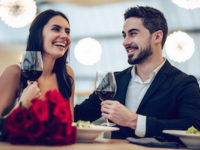 Couple having a romantic dinner during their romantic getaway in Maine