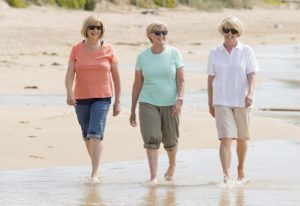 3 women walking down the beach in Rockland, Maine