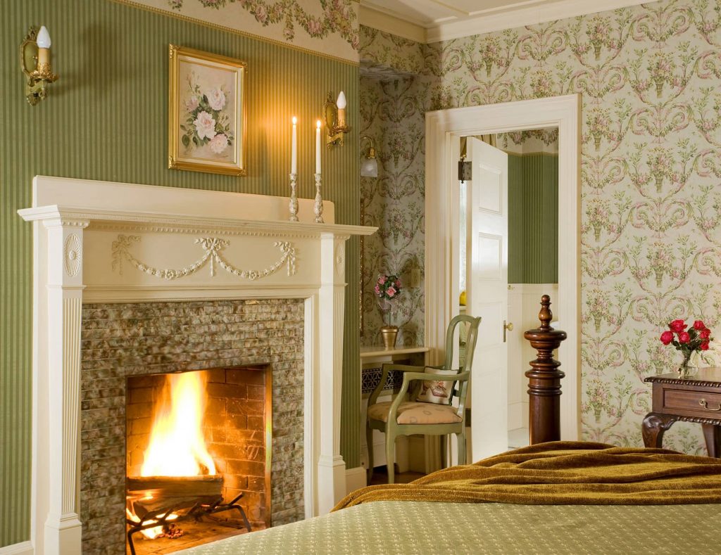 Warm fireplace at the foot of the bed in Room 1