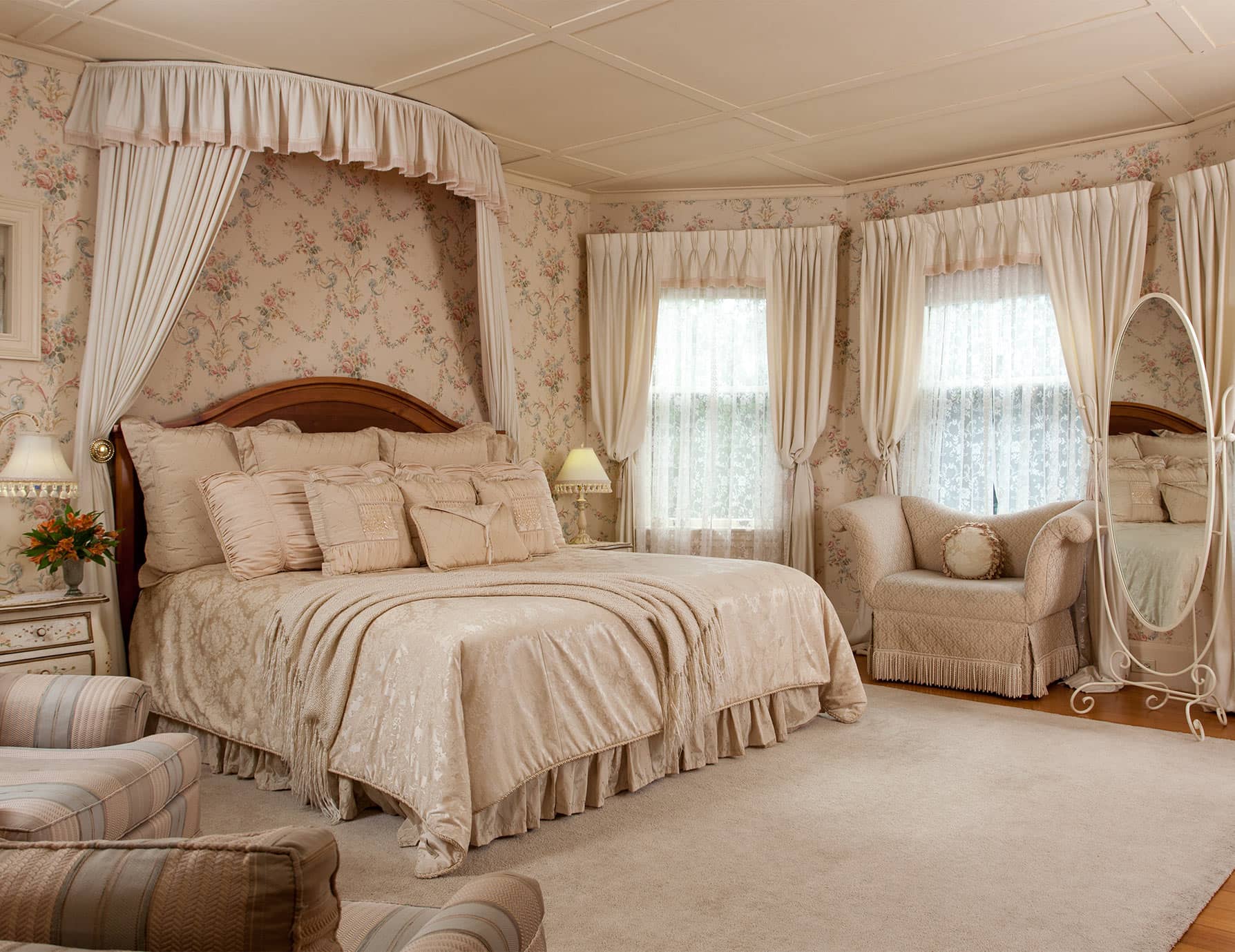Large, soft bed in room with tall windows and sitting areas in room 3