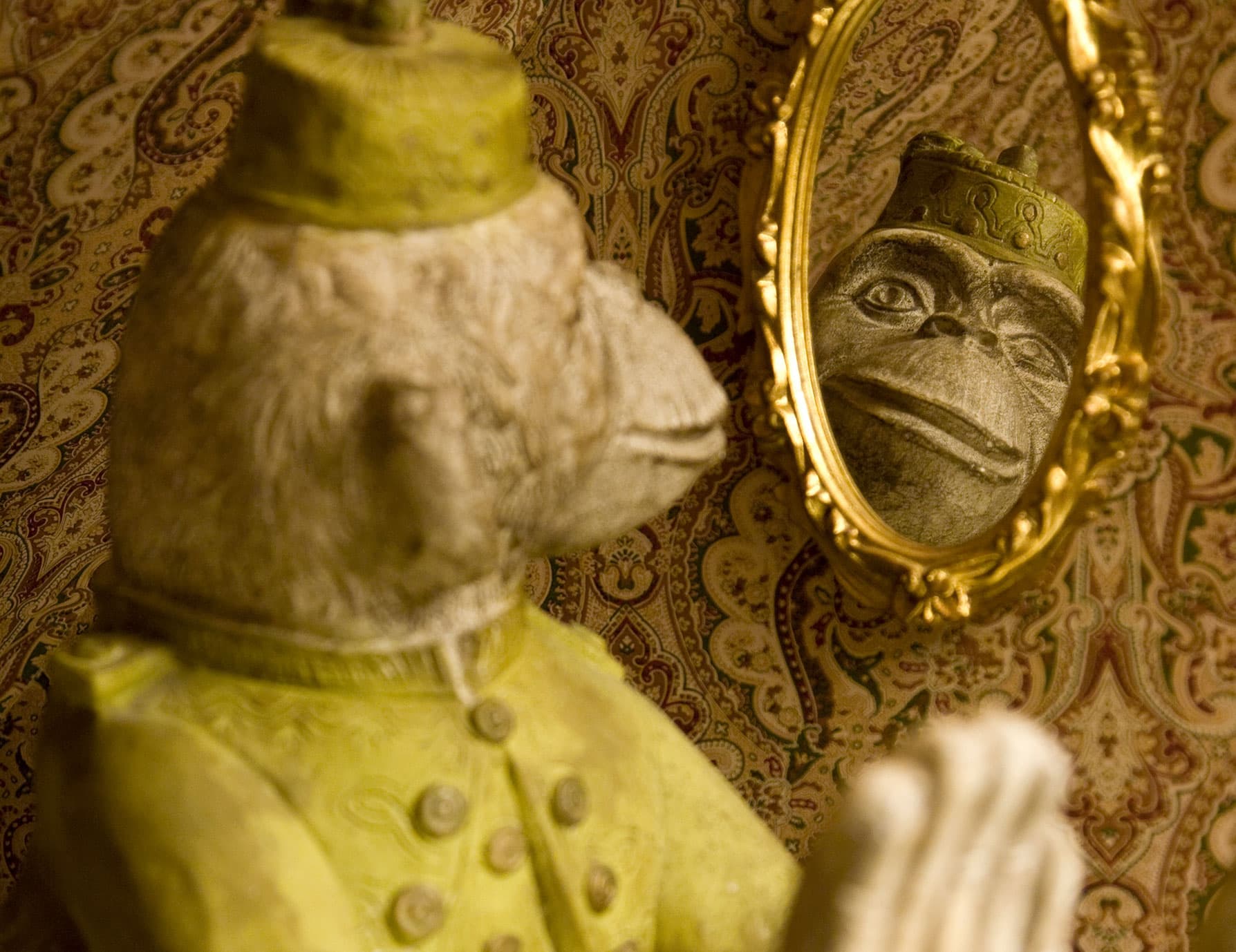 Fun monkey statuette looking in the mirror