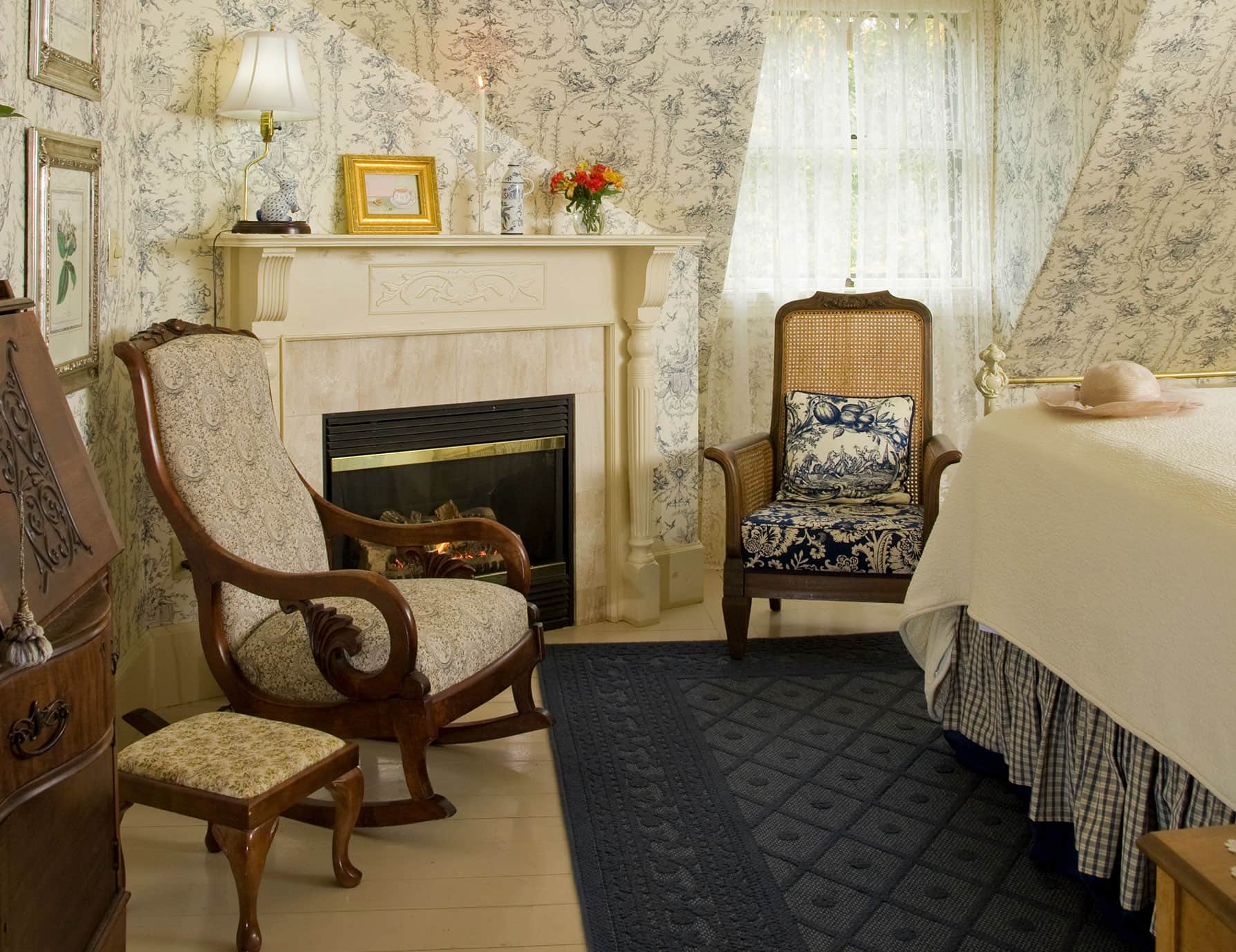 Sitting area with comfortable wooden chairs and fireplace