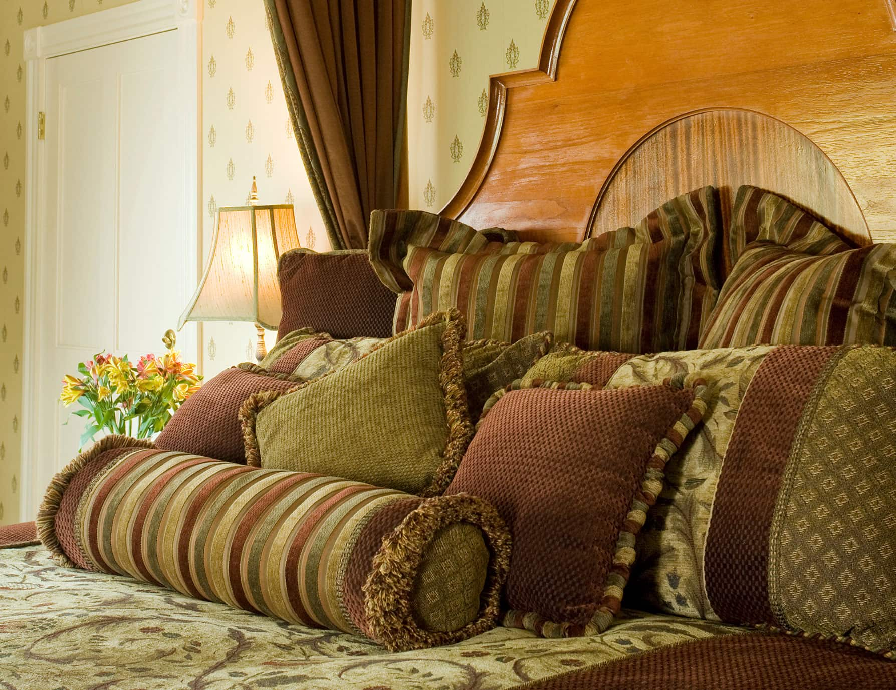 Mountain of soft decorative pillows on the bed in Room 9