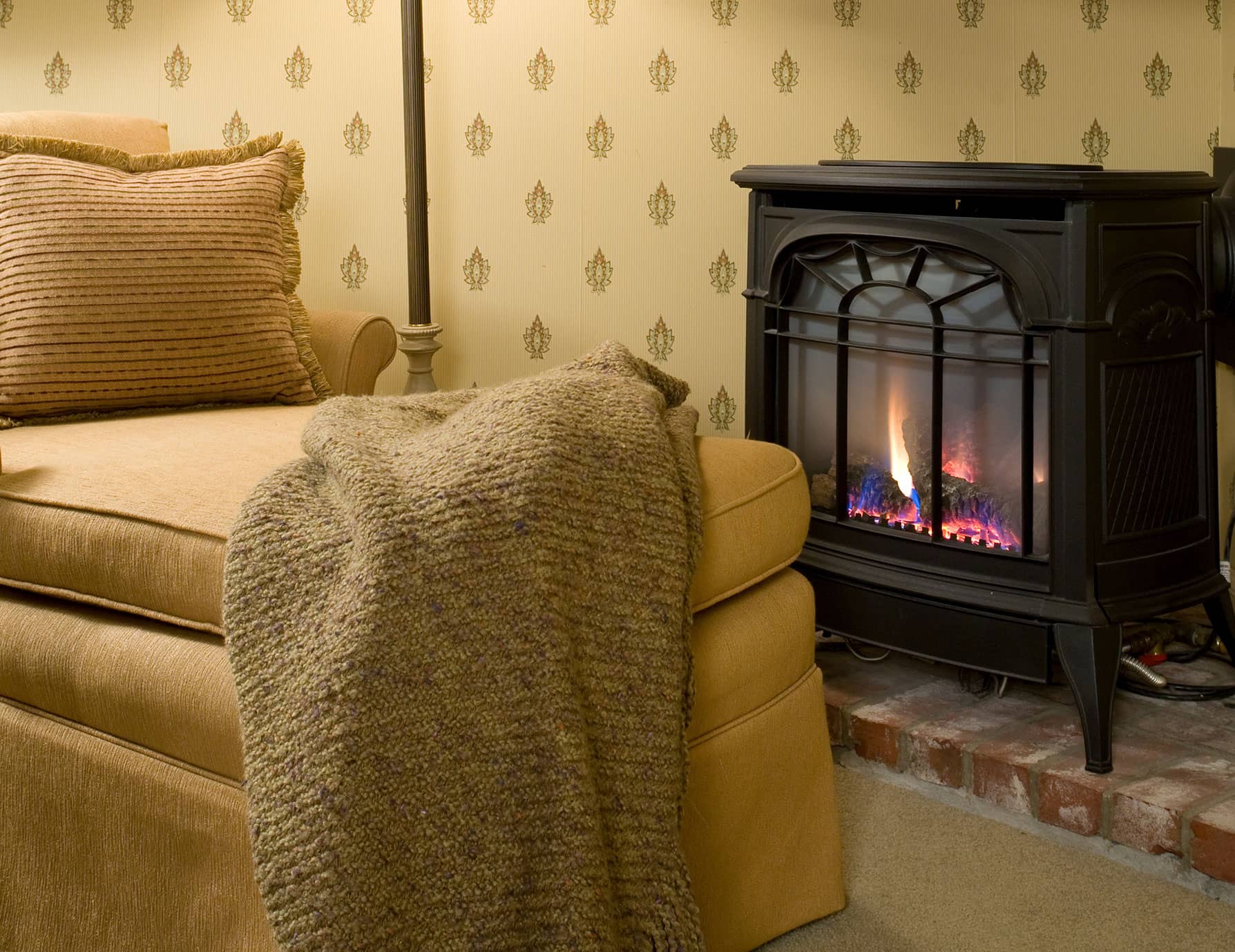 Sitting area with fireplace, lamp, and bookshelf