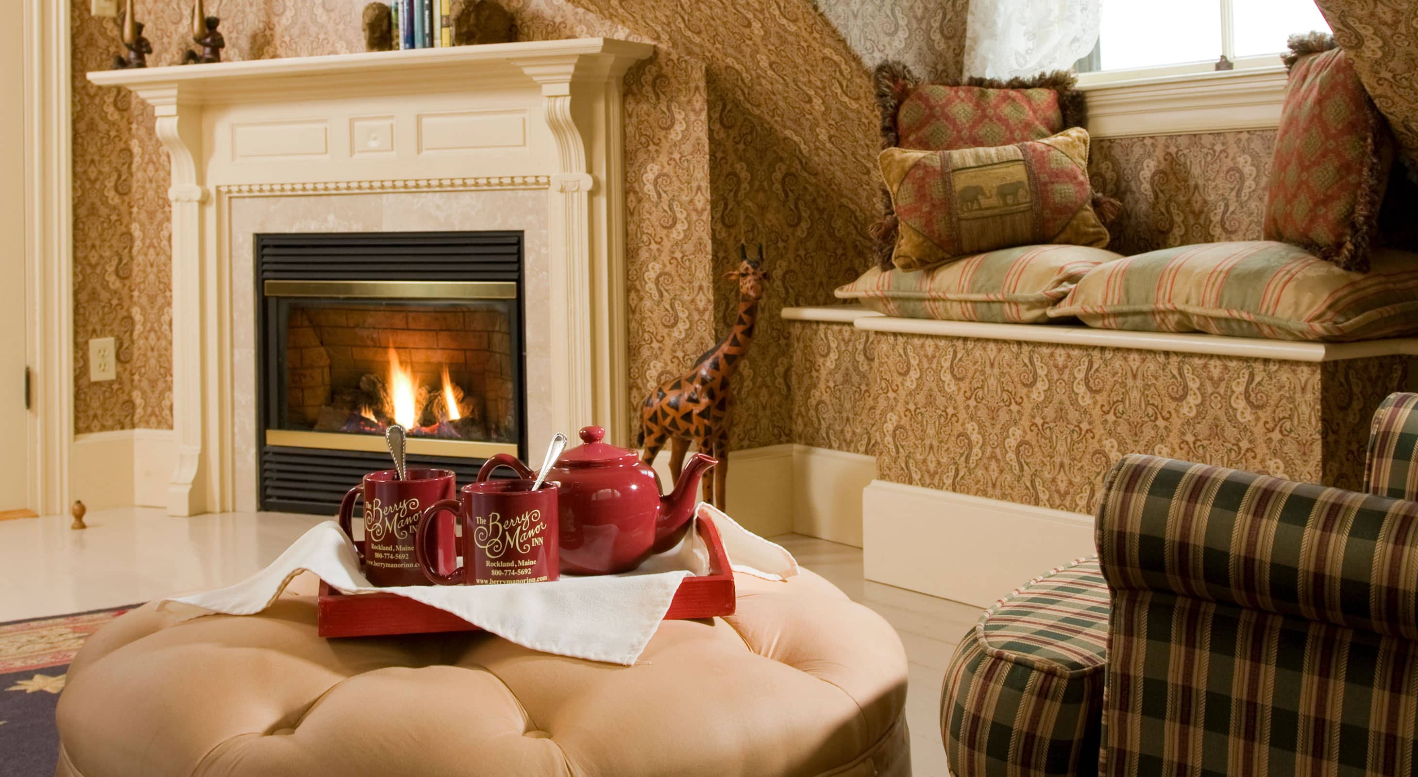 Tray of tea on ottoman in sitting area by fireplace at our bed and breakfast near Camden