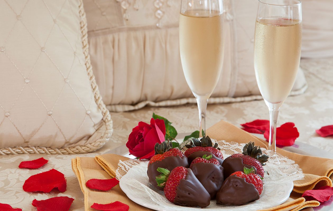 Chocolate-dipped strawberries with rose petals and sparkling cider - the perfect romantic enhancement for getaways at our Lodging in Rockland, Maine.