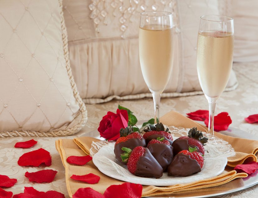 Chocolate-dipped strawberries with rose petals and sparkling cider - the perfect romantic enhancement for getaways at our Lodging in Rockland, Maine.