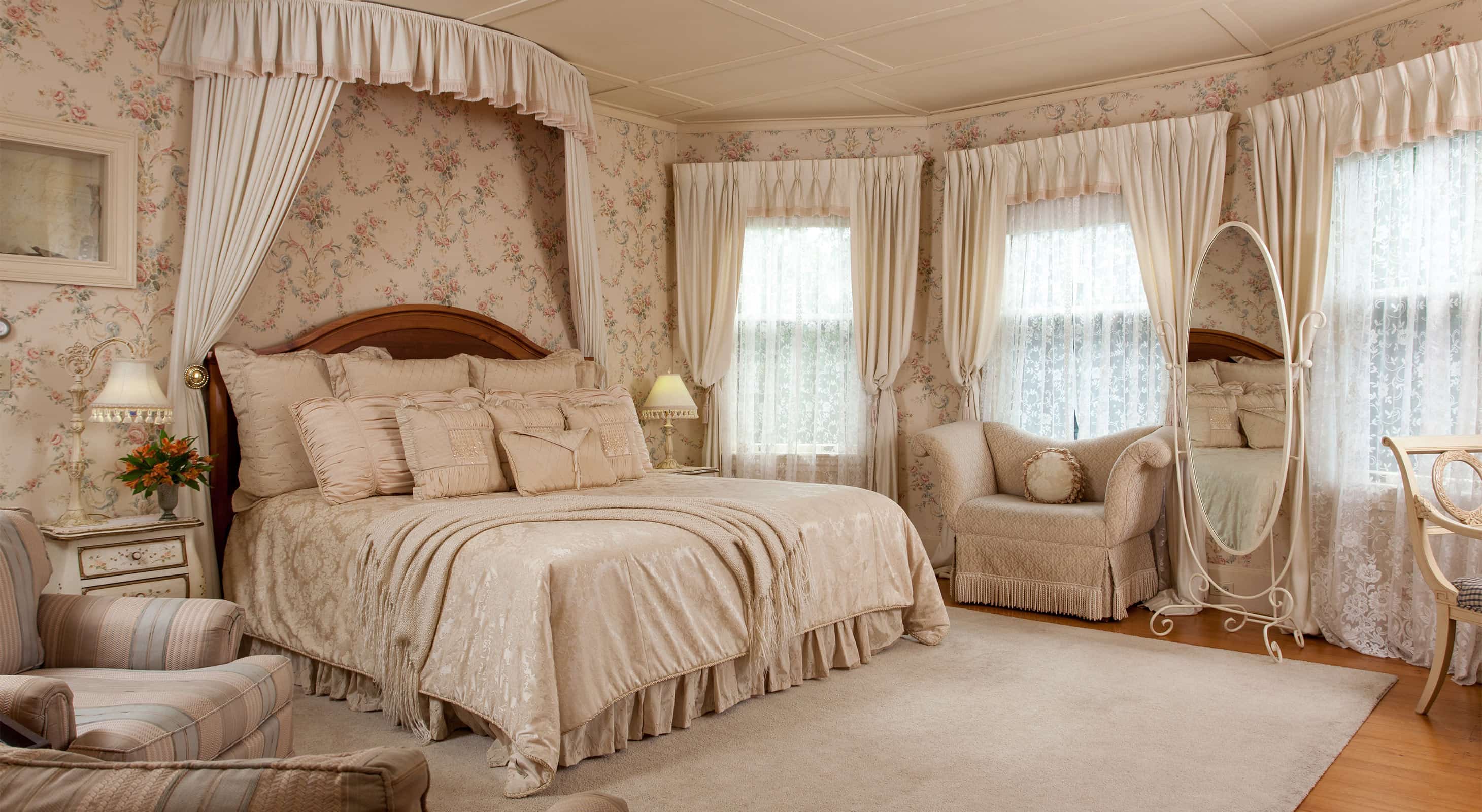 Large, soft bed in room with tall windows and sitting areas in room 3