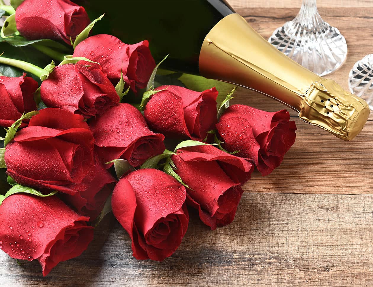 Bottle of Sparkling Wine and Red Roses