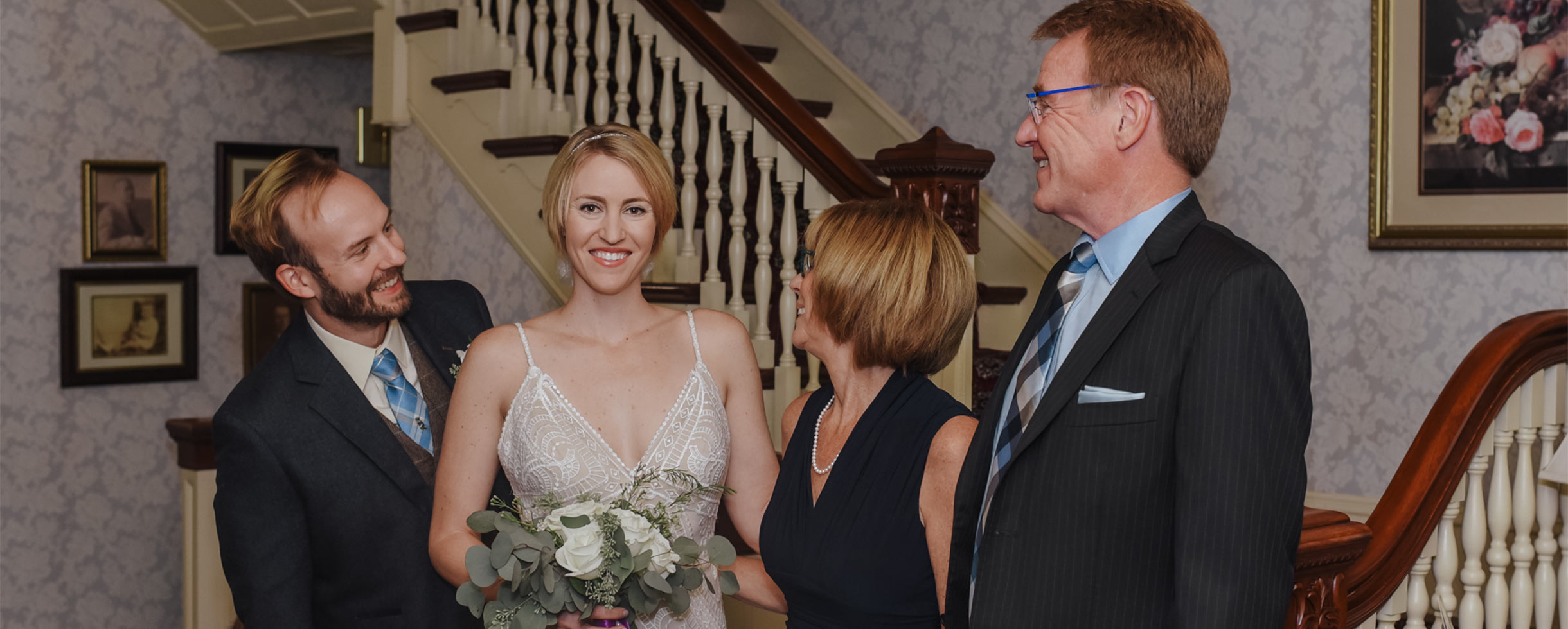 Bride and groom with two guests inside Berry Manor Inn