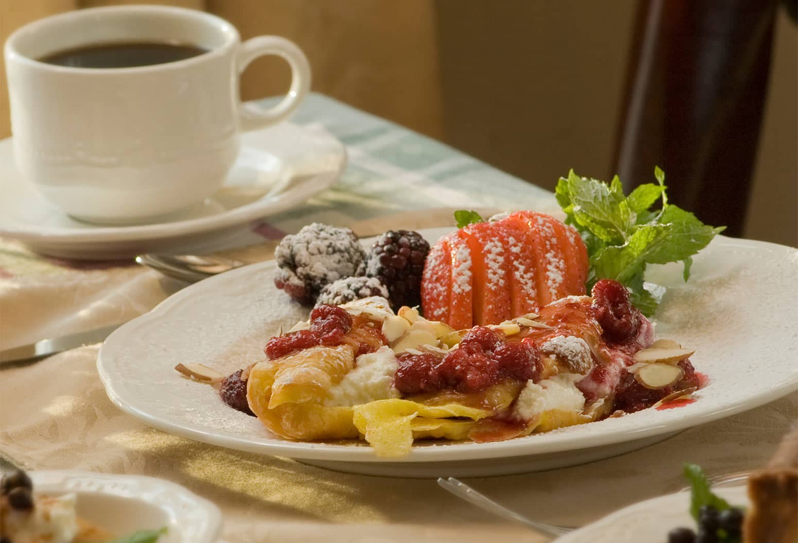 Breakfast pastry and fruit with coffee