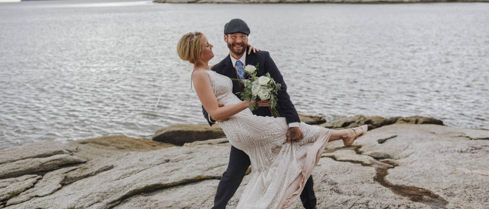 Bride and Groom on Rock in front of water