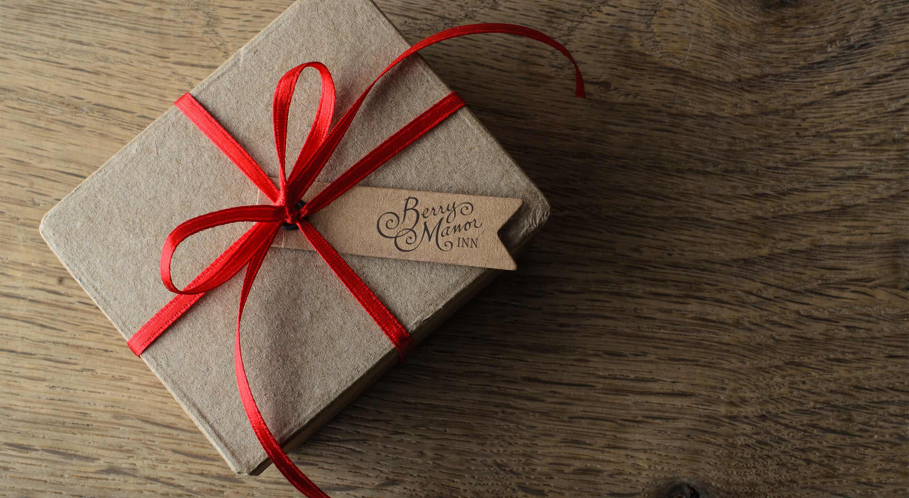 Gift Box with red bow and Berry Manor Inn logo