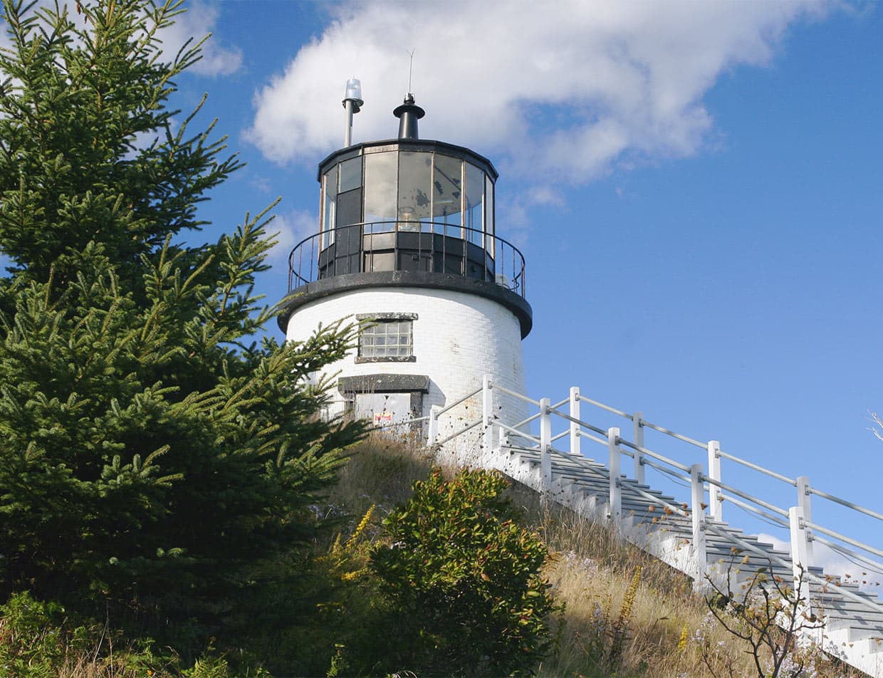 Owls Head Lighthouse against a blue sky