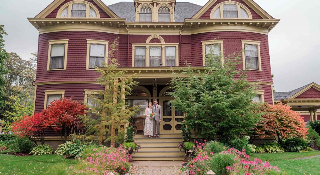 Bride and Groom on the Porch of Berry Manor Inn