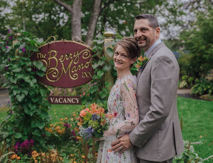 Bride and Groom by our sign, enjoying a romantic escape on the MidCoast of Maine