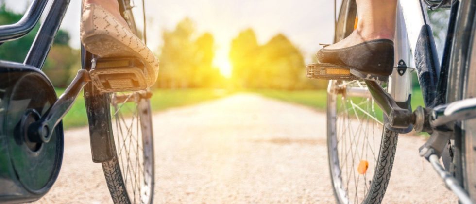 Two bicyclists riding into the sunset.