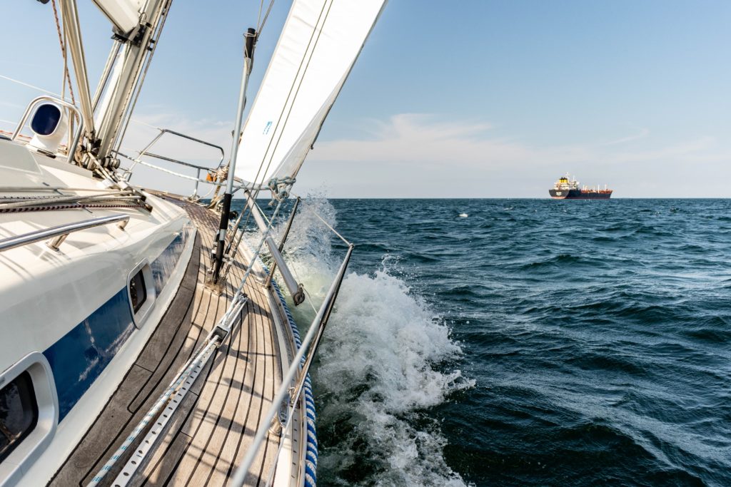 View from the side of a sailboat sailing through the open seas