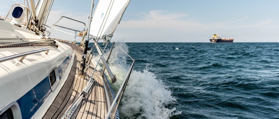 View from the side of a sailboat sailing through the open seas