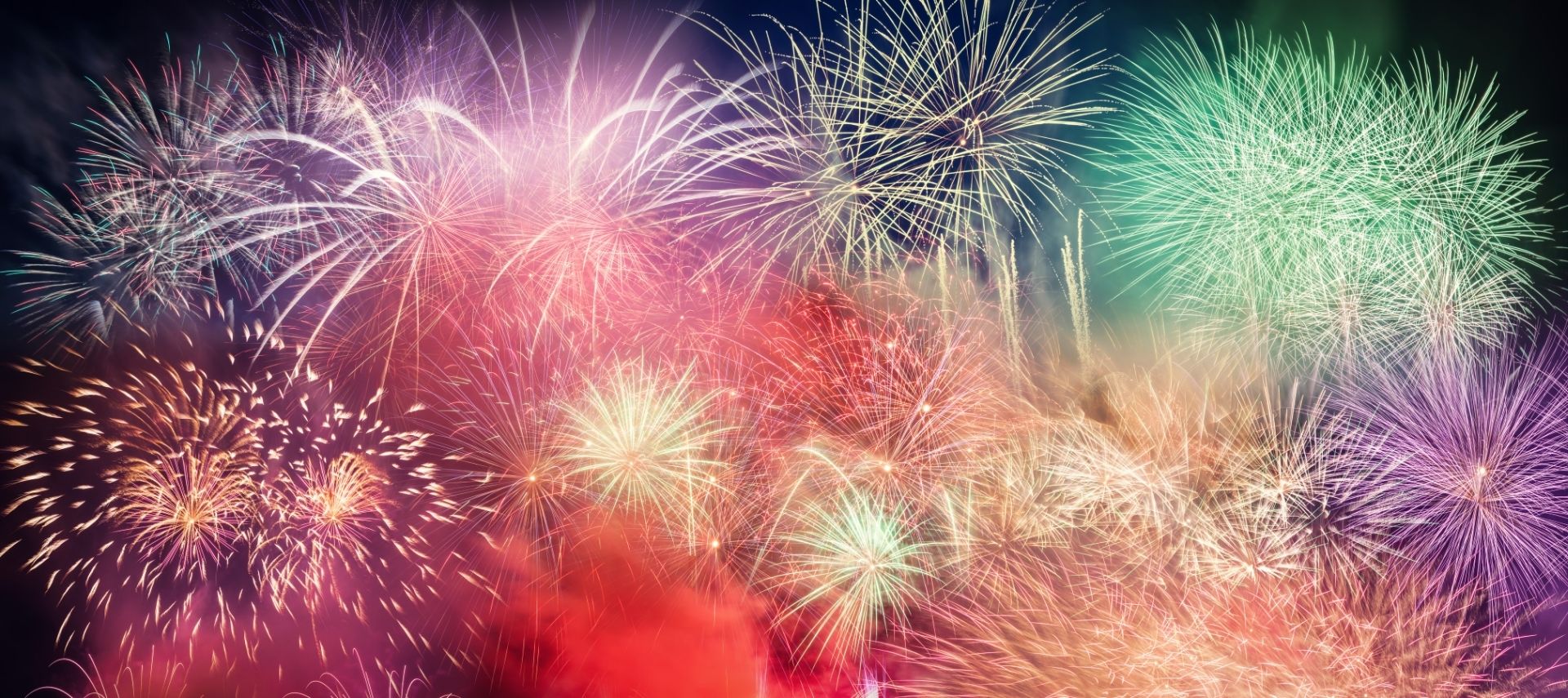 Fireworks bursts in a rainbow of colors in the dark sky