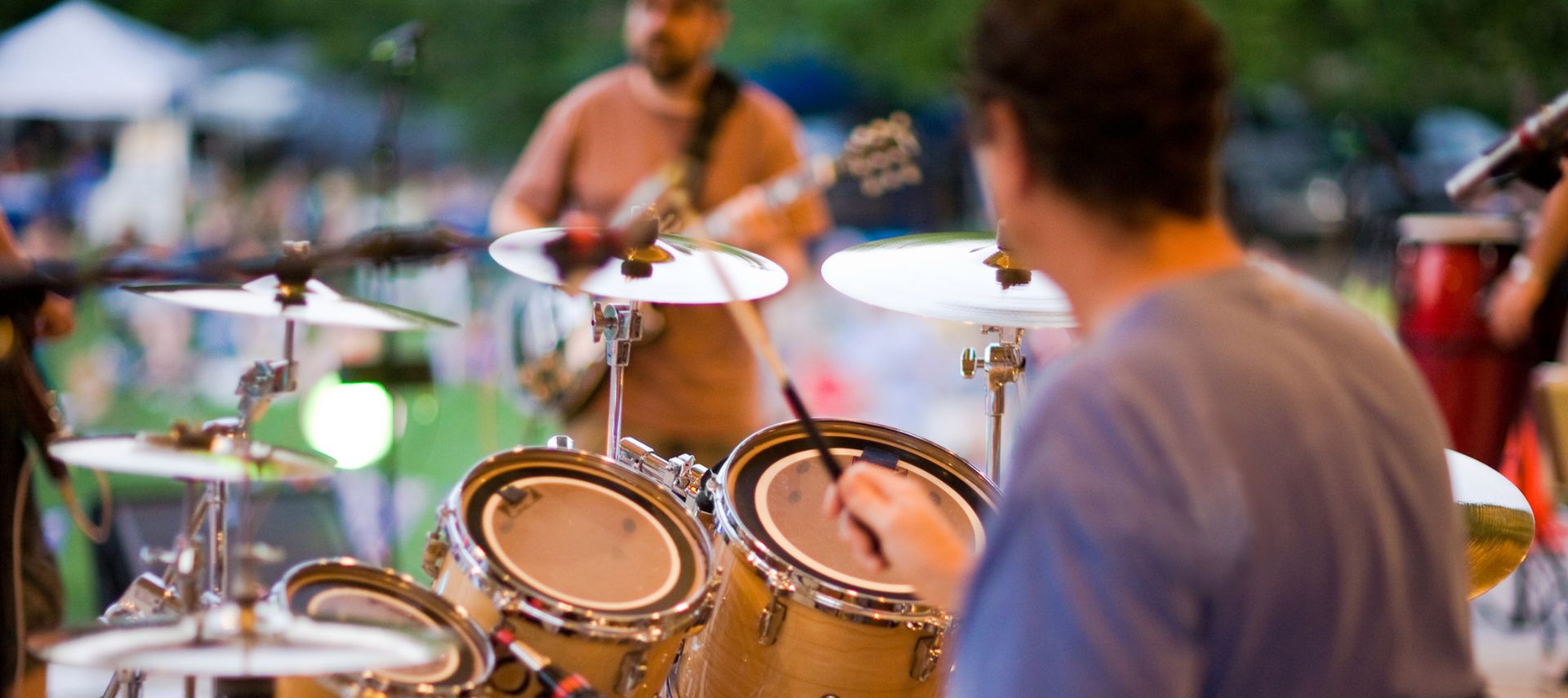 person playing drums at an outdoor venue