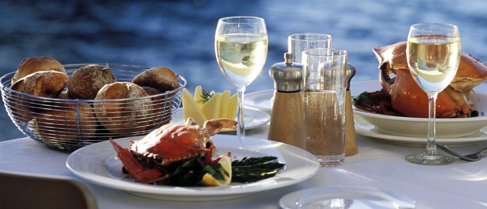 Dining table set with fresh seafood overlooking the water