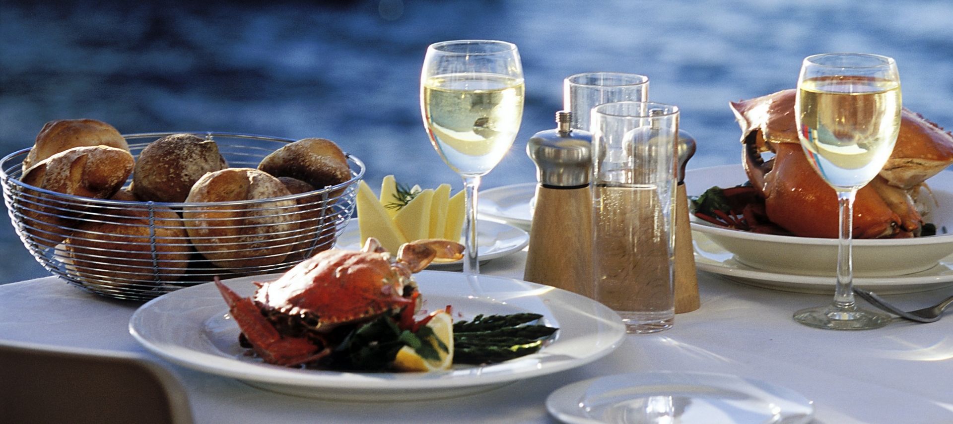 Dining table set with fresh seafood overlooking the water