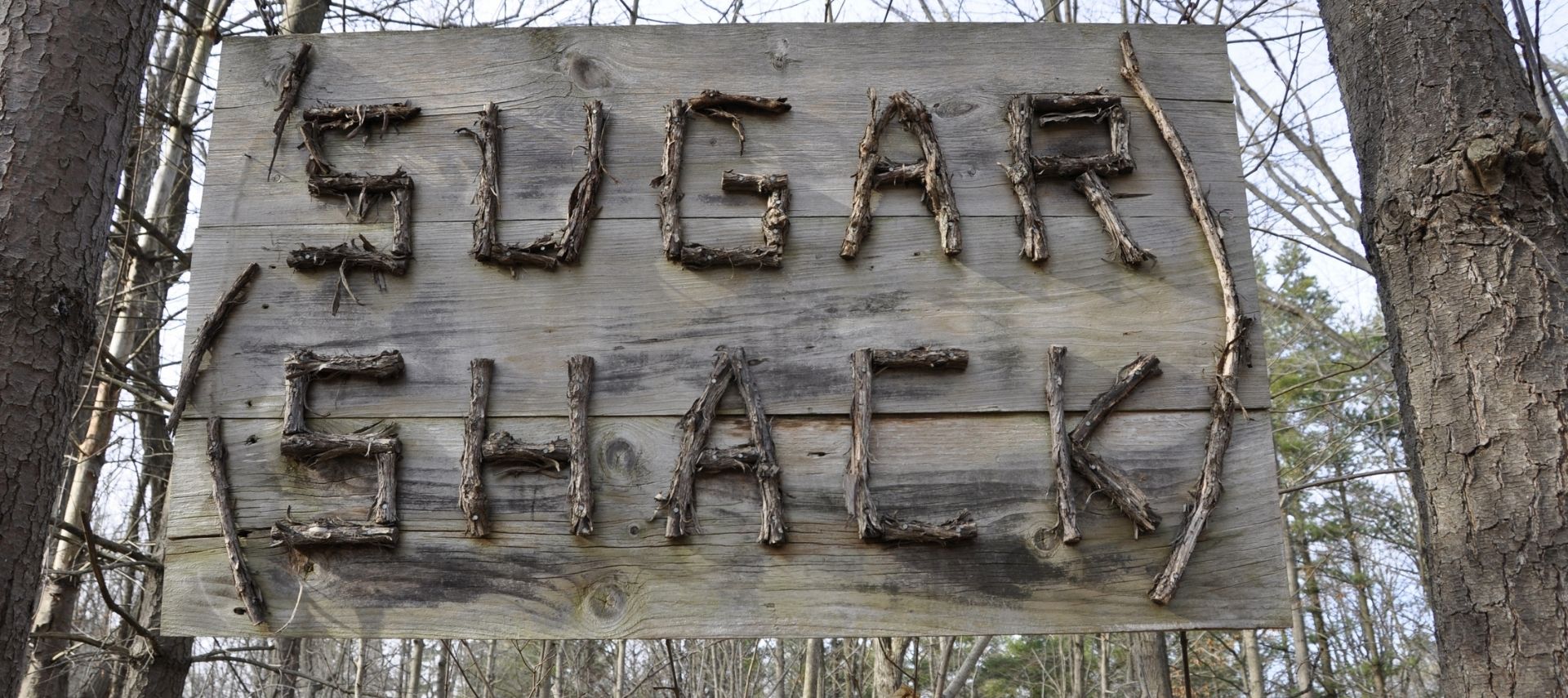 Sugar shack sign made of wood and sticks