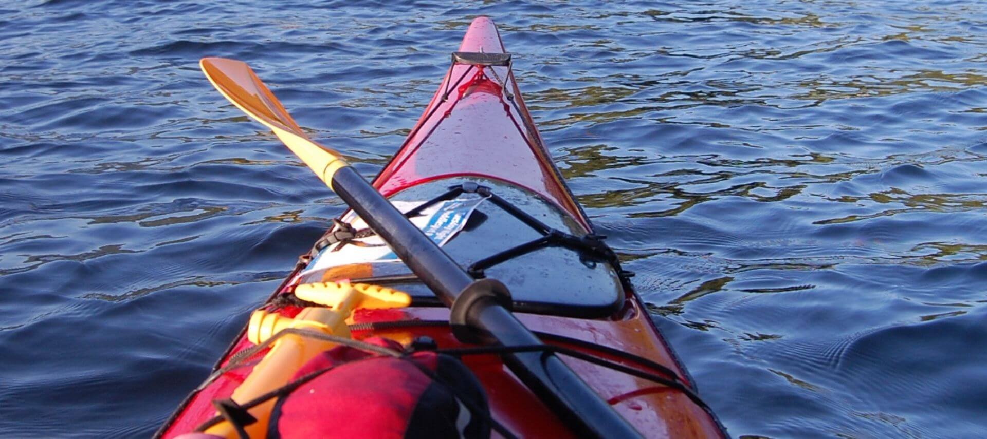 The front of a kayak in the water