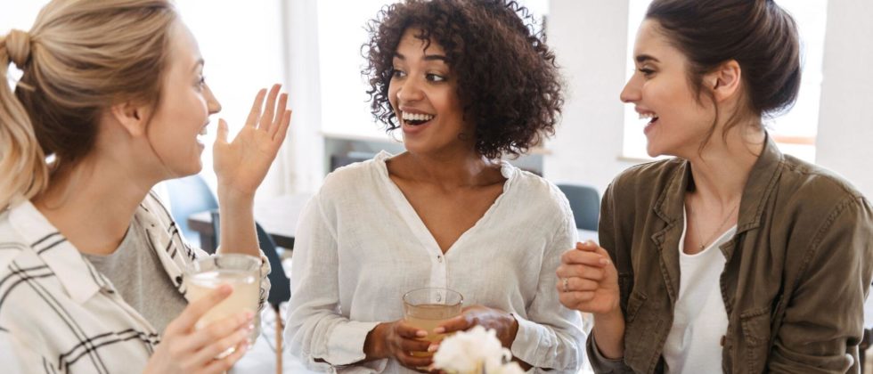 Three ladies enjoying conversation over drinks