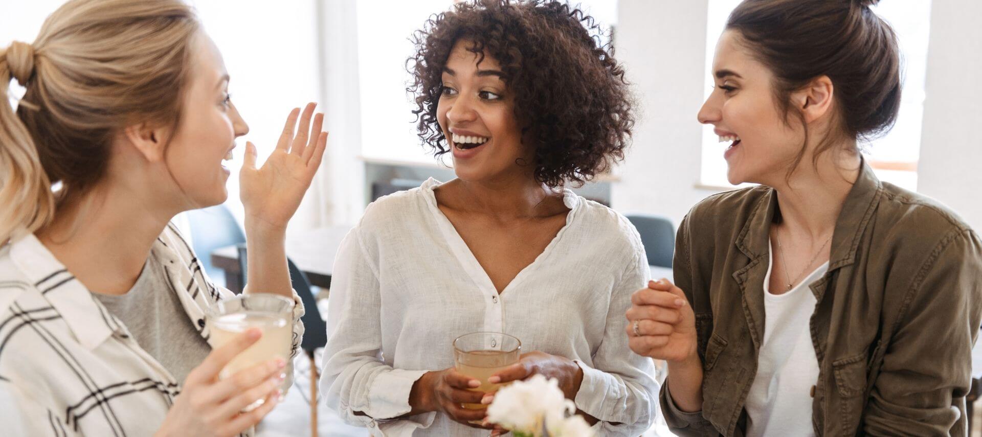 Three ladies enjoying conversation over drinks