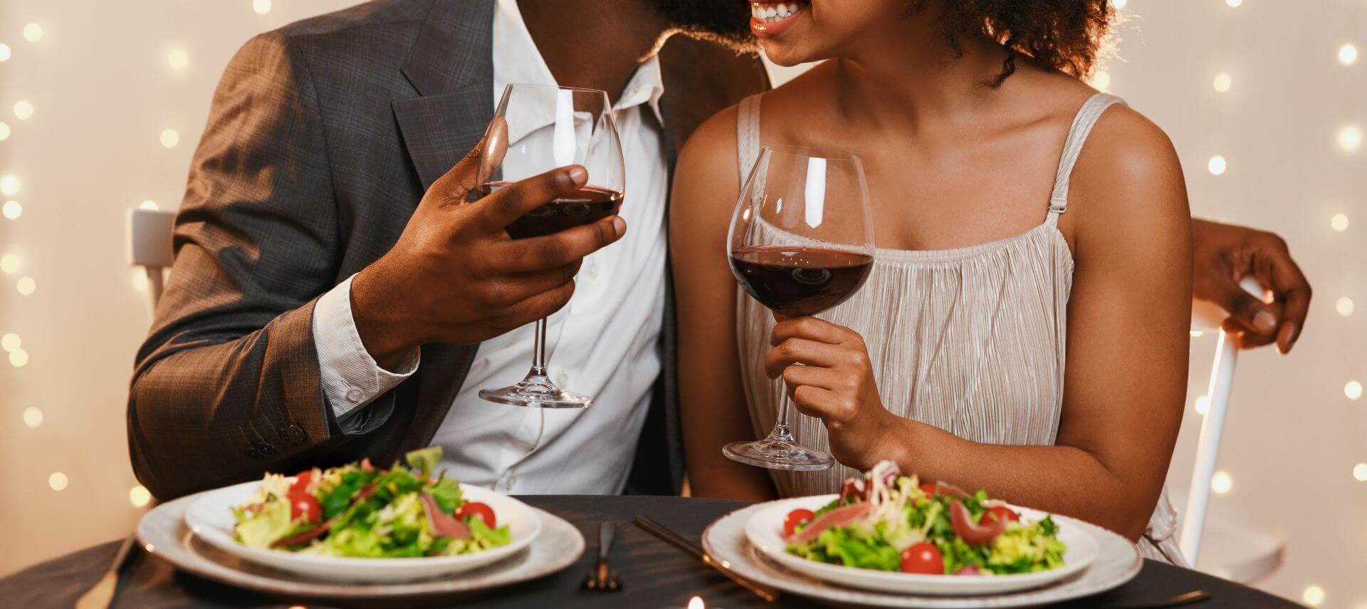 A couple cuddling while dining