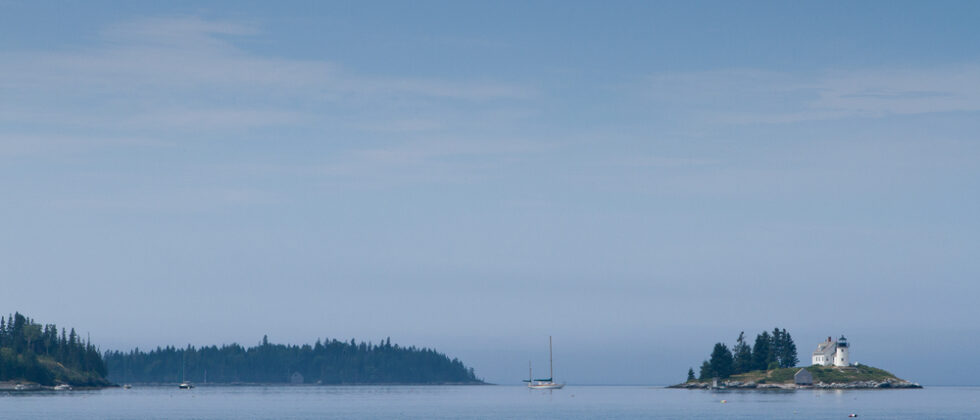 sailing past the Pumpkin Island Lighthouse in Penobscot Bay in Maine
