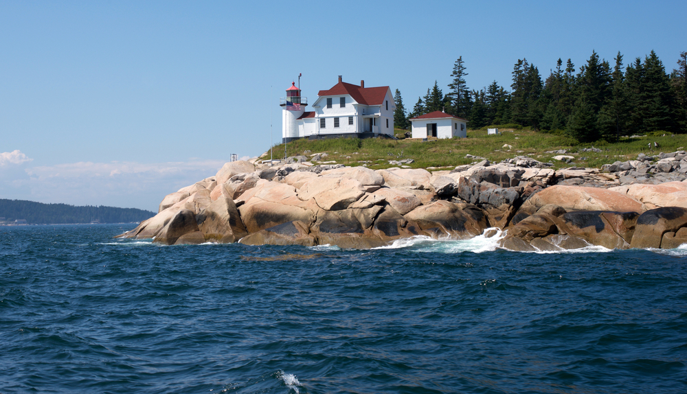 Learn more about lighthouses at the Maine Lighthouse Museum. Picture of Heron Neck Lighthouse on a bluff.