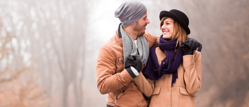Enjoy one of the best weekend getaways in Maine. A couple embraces while walking down a treelined path.